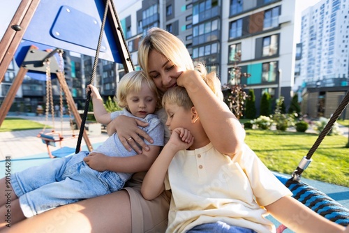 Mother Enjoying Quality Time With Two Sons at Playground During Sunny Afternoon