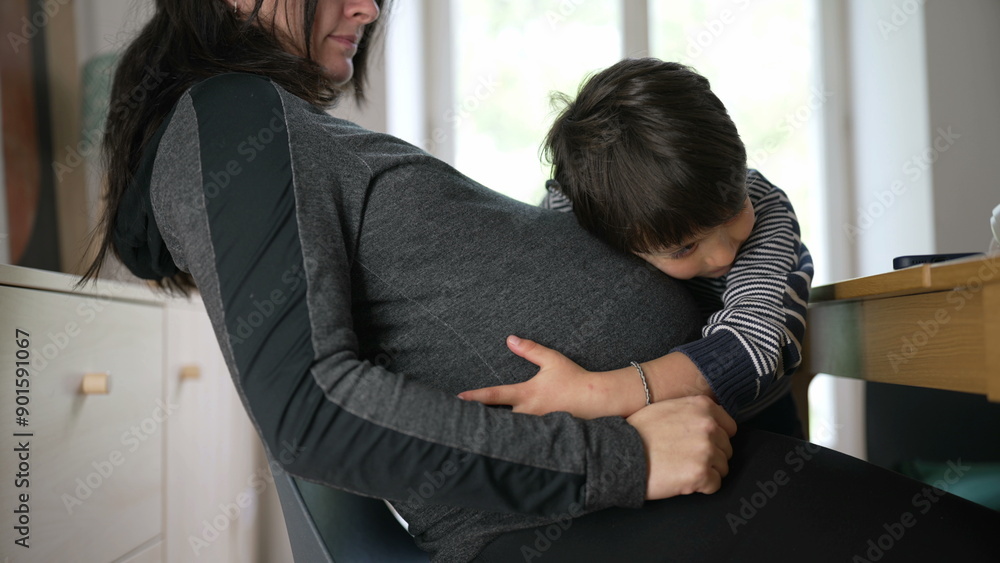 Pregnant woman with her young child embracing her belly, capturing a candid and tender moment of love and connection between mother and child at home Pregnant woman with her young child embracing her belly, capturing a candid and tender moment of love and connection between mother and child at home