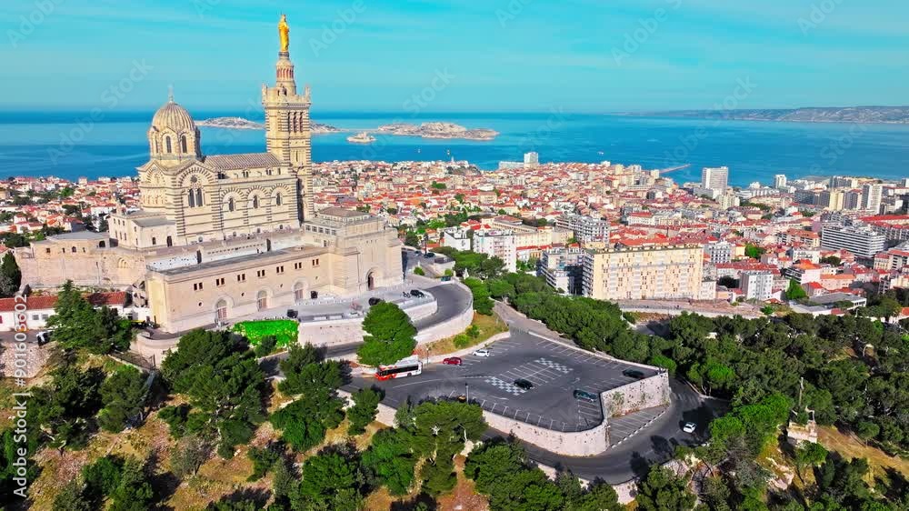 Grand basilica on top of a hill crowned by a golden statue, old city centre and port by blue Mediterranean sea coast in Marseille, France. Basilica of Notre Dame of la Garde at Marseille in France. Grand basilica on top of a hill crowned by a golden statue, old city centre and port by blue Mediterranean sea coast in Marseille, France. Basilica of Notre Dame of la Garde at Marseille in France.