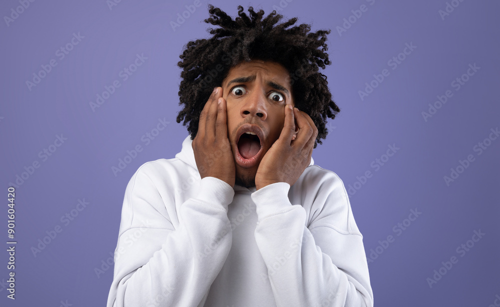 Code Black Scared Black teen guy feeling scared, shouting in panic on violet studio ...