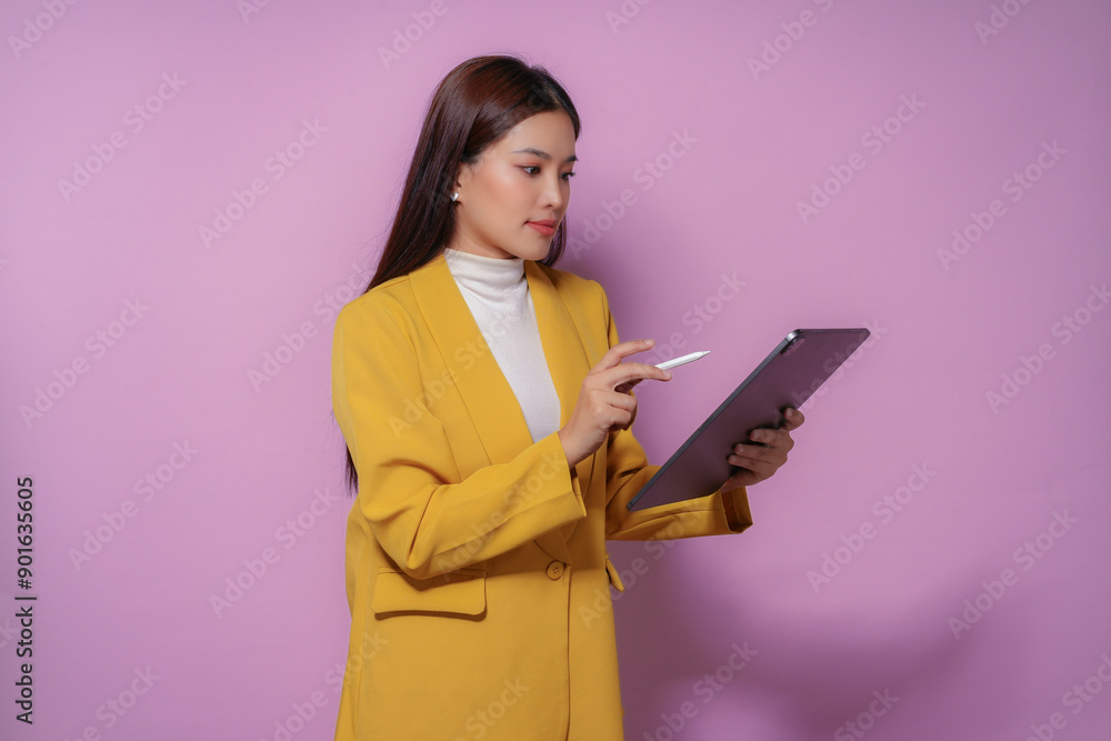 Businesswoman is using a digital tablet and stylus, showcasing modern technology in a professional setting Businesswoman is using a digital tablet and stylus, showcasing modern technology in a professional setting