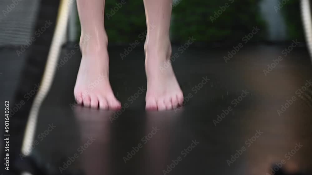 child jumping on trampoline in rain child jumping on trampoline in rain