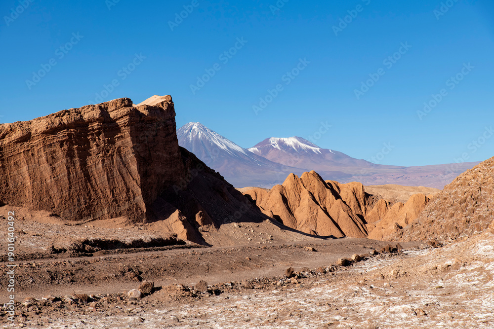 Valle de la Luna (Valley of the Moon) stone and sand formations and stratovolcano Licancabur in background in high altitude Atacama desert near San Pedro de Atacama, Antofagasta, Chile Valle de la Luna (Valley of the Moon) stone and sand formations and stratovolcano Licancabur in background in high altitude Atacama desert near San Pedro de Atacama, Antofagasta, Chile