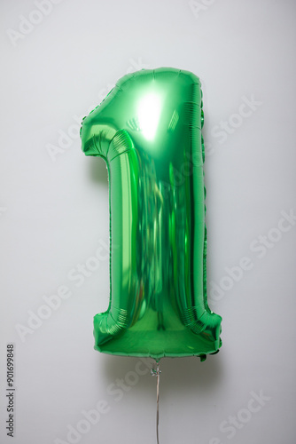green foil number 1 balloon on white background