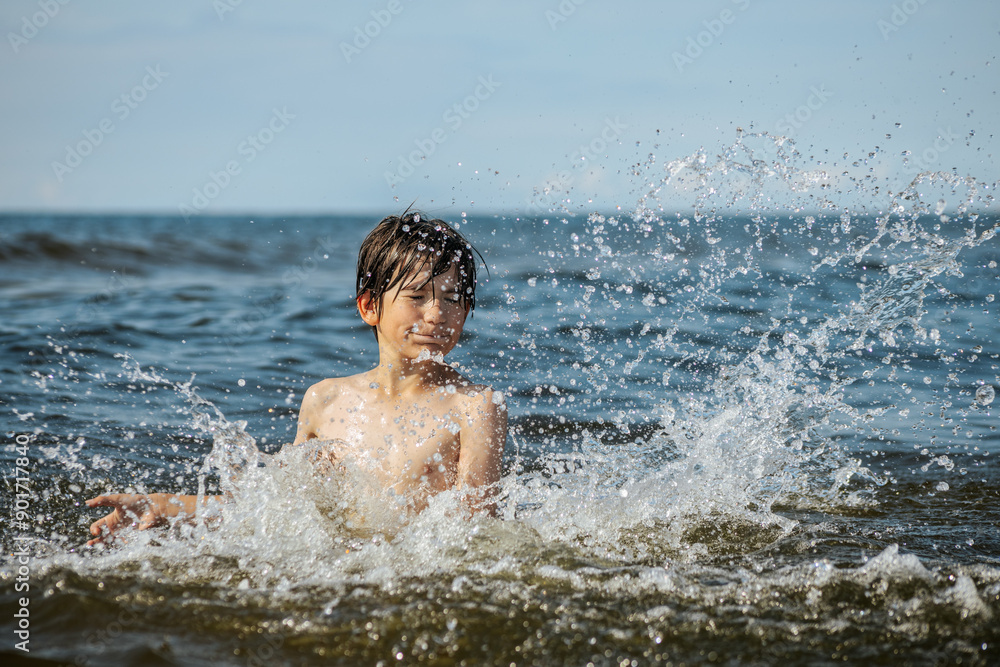A young child struggling and shouting in the water, appearing to be in distress, with splashes around him and a vast expanse of water in the background. The scene evokes a sense of urgency and concern A young child struggling and shouting in the water, appearing to be in distress, with splashes around him and a vast expanse of water in the background. The scene evokes a sense of urgency and concern