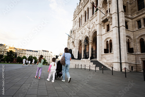 Wallpaper Mural Family walking together in front of a historic European building in a city Budapest, Hungary. Torontodigital.ca