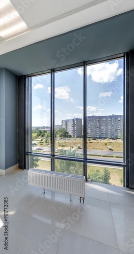 vertical loop rotation and panoramic view in empty modern hall with columns, doors and panoramic windows overlooking the city.