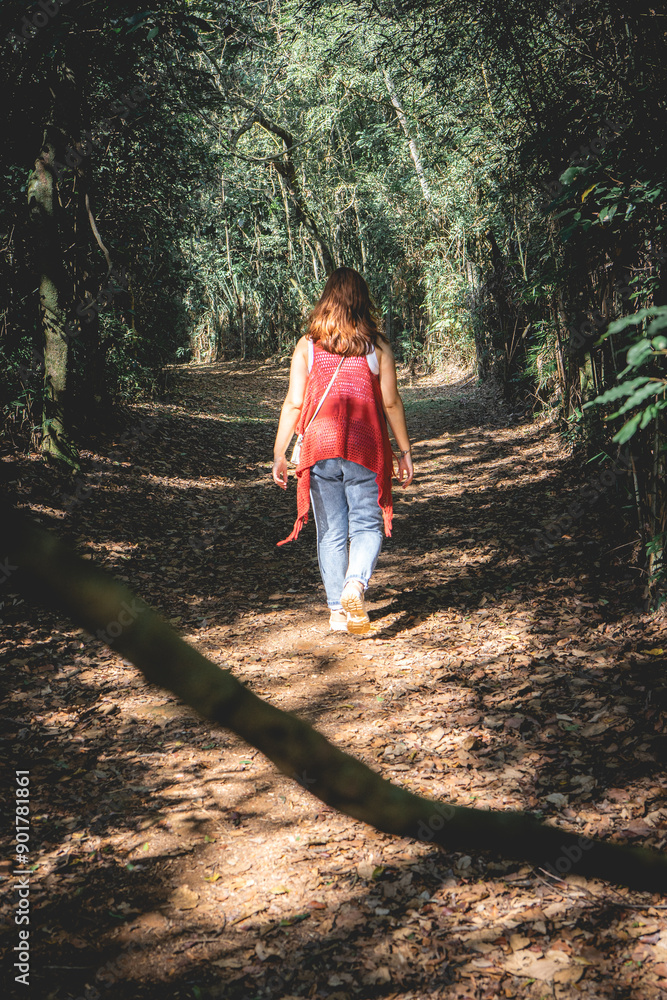 Brazilian Woman with a red sweater, having a walk in The Botanic Garden in São Paulo, Brazil. Brazilian Woman with a red sweater, having a walk in The Botanic Garden in São Paulo, Brazil.