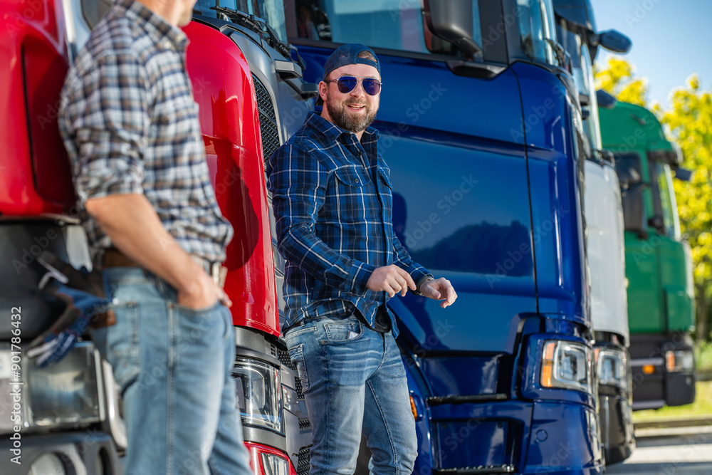 Men Discussing Trucks at a Transportation Yard on a Sunny Day Men Discussing Trucks at a Transportation Yard on a Sunny Day