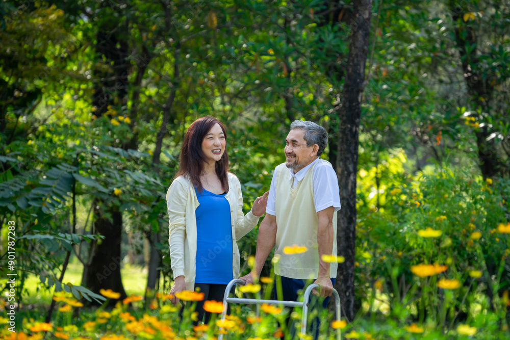 happy family,senior man talking and relaxing with young adult daughter in the nature park while practice walking with walker happy family,senior man talking and relaxing with young adult daughter in the nature park while practice walking with walker