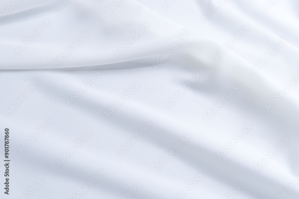 Fototapeta premium White fabric texture with a curve. Close-up soft fabric texture background with stylish, minimal, bright, crumple, fashionable textiles for wallpaper. Texture background of wavy white fabric.