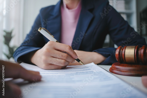 Obraz na płótnie Lawyer is signing a last will and testament during a meeting with a client in th