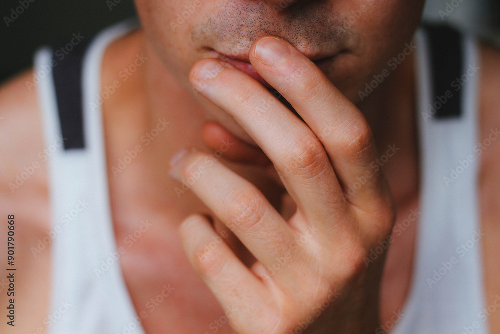 Closeup of young man thinking , fingers on lips . Closeup of young man thinking , fingers on lips .