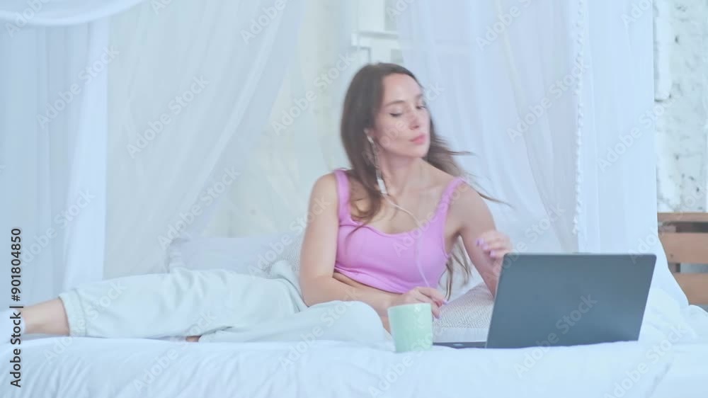 Brunette puts wireless headphones in her ears. Turning on the music meditation Brunette puts wireless headphones in her ears. Turning on the music meditation