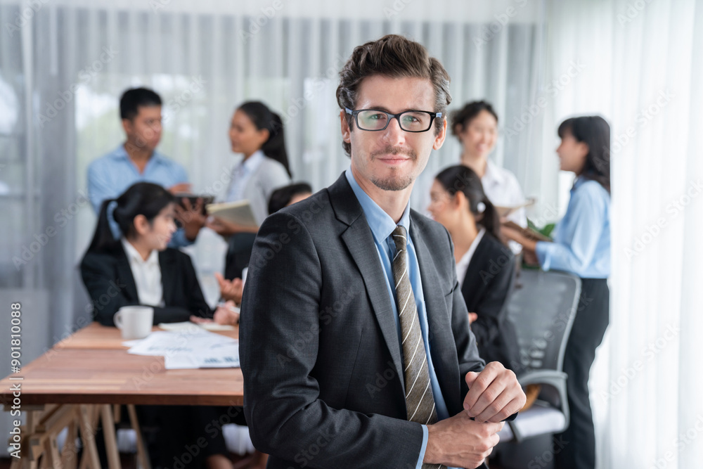 Portrait of happy businessman looking at camera with motion blur background of business people movement in dynamic business meeting. Habiliment Portrait of happy businessman looking at camera with motion blur background of business people movement in dynamic business meeting. Habiliment