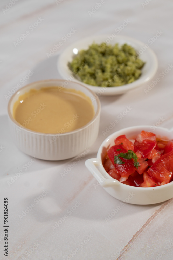 Red, yellow and green sauce in bowls on light background Red, yellow and green sauce in bowls on light background