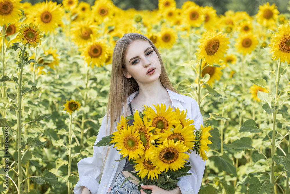 Young beautiful woman with a bouquet of sunflowers Young beautiful woman with a bouquet of sunflowers