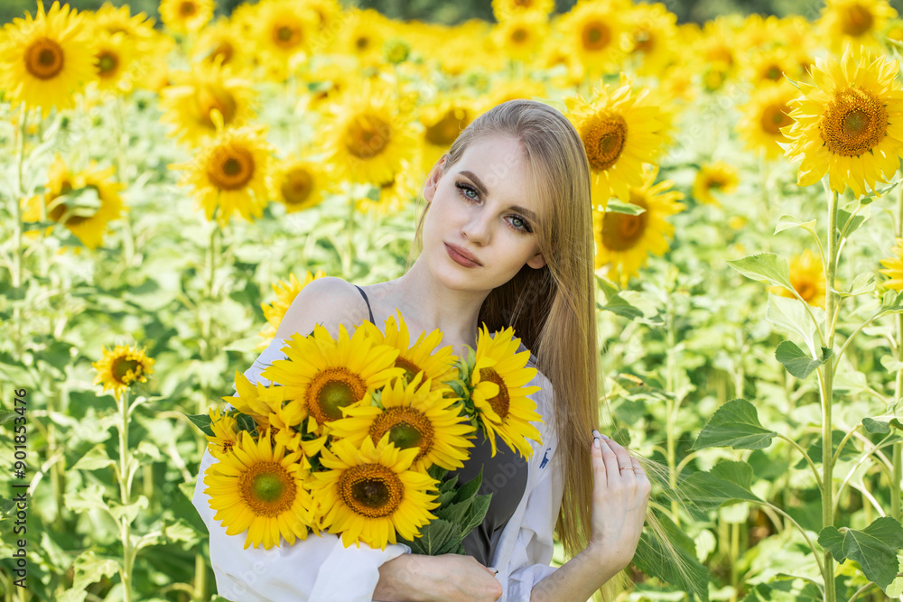 Young beautiful woman with a bouquet of sunflowers Young beautiful woman with a bouquet of sunflowers