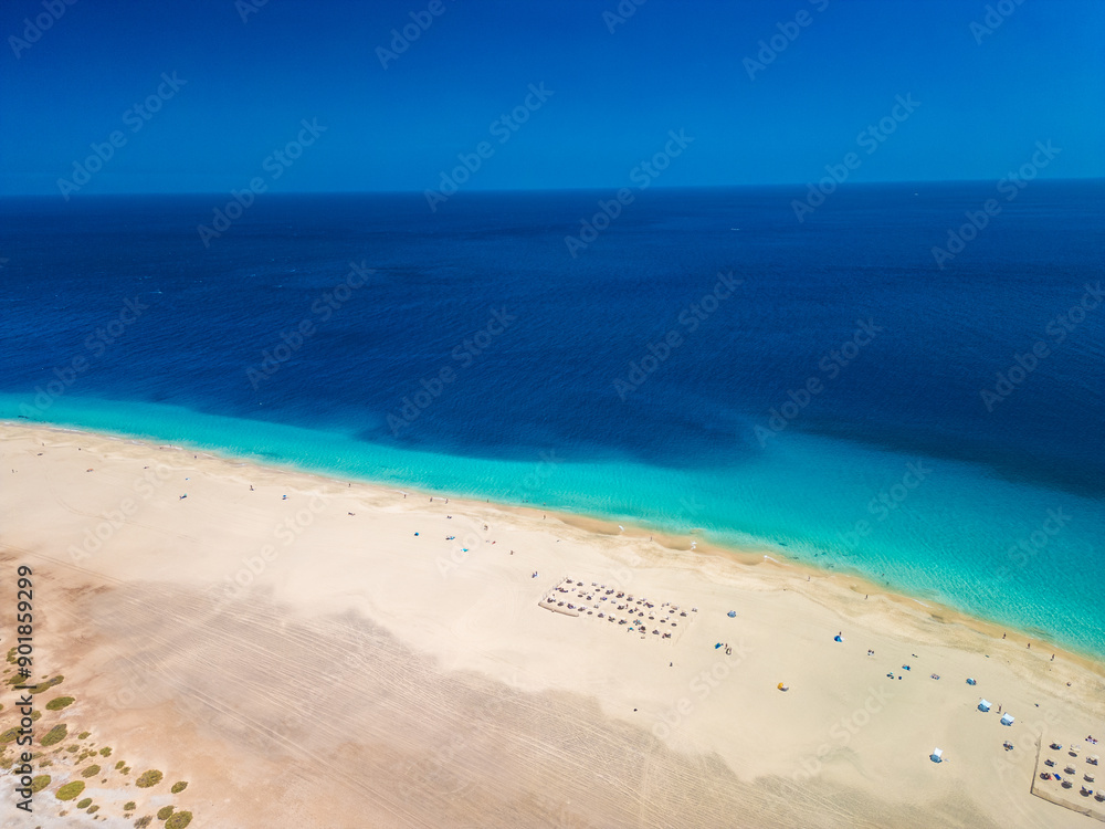 White sandy beach and blue water in Morro Jable, south of Fuerteventura, Canary islands White sandy beach and blue water in Morro Jable, south of Fuerteventura, Canary islands