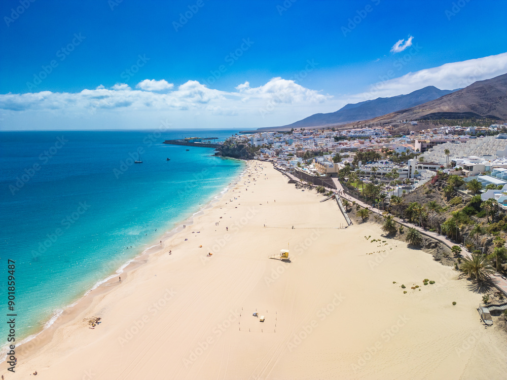 White sandy beach and blue water in Morro Jable, south of Fuerteventura, Canary islands White sandy beach and blue water in Morro Jable, south of Fuerteventura, Canary islands