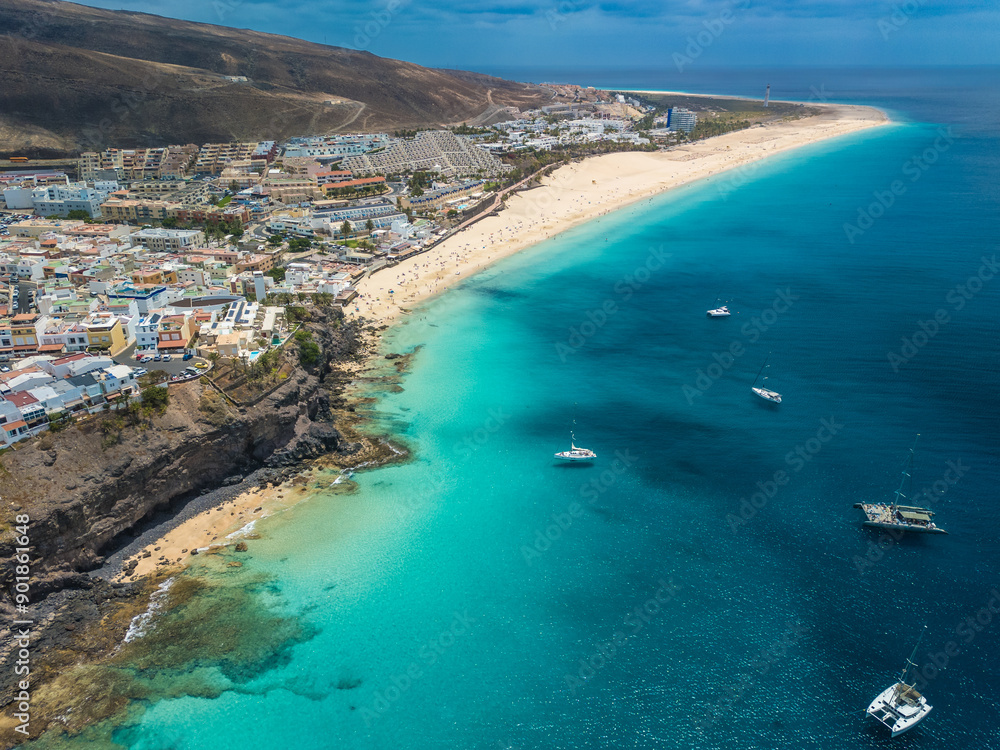 White sandy beach and blue water in Morro Jable, south of Fuerteventura, Canary islands White sandy beach and blue water in Morro Jable, south of Fuerteventura, Canary islands