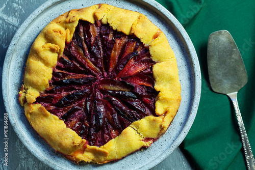 Obraz na płótnie Traditional french pie galette made of corn dough with plum filling on a concrete tray. w salonie