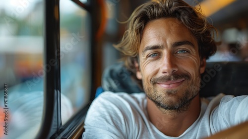 A man sits in a train compartment with a gentle smile, capturing the essence of relaxation and contentment, with blurred train scenery in the background.