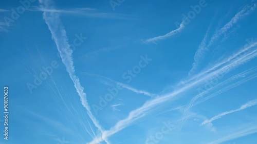Dramatic Chemtrails Streaking Across a Blue Sky