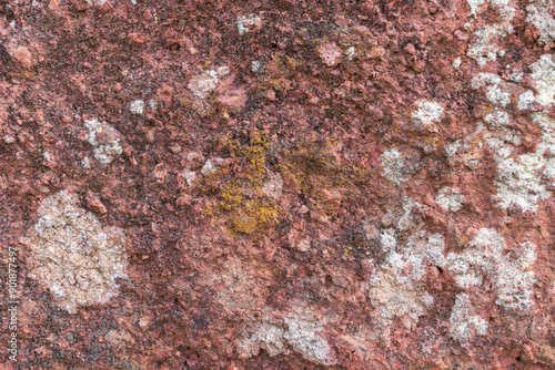 Detailed texture of an ancient natural stone wall with a rustic finish and authentic organic features