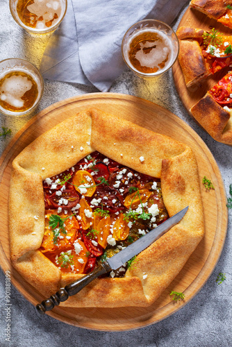 Obraz na płótnie Traditional open pie galette with tomatoes, cheese and herbs, served with beer or wine. w salonie