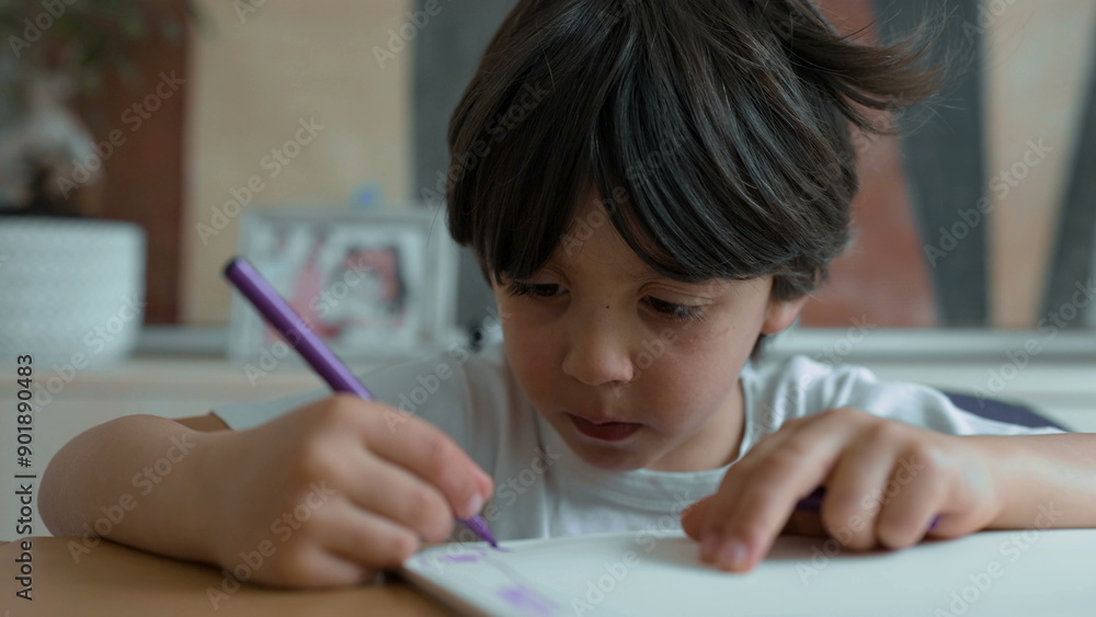 Child concentrating on drawing with a purple marker, detailed close-up of hand and paper, showcasing artistic creativity in a serene home setting, focus on childhood art and learning