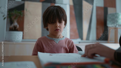 Child reluctant and struggling with learning, showing frustration and difficulty during a learning activity, highlighting the challenges of education in a supportive home environment