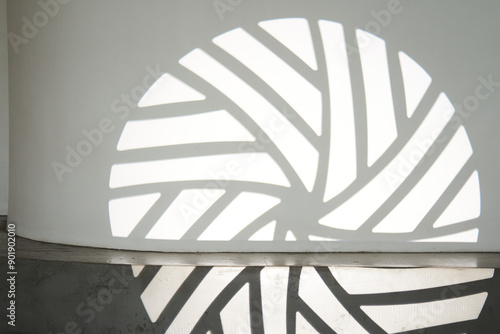 The silhouette of the gobo mask on the wall surface with space to copy. A step ledge with a shadow from a light stroke. High quality photo