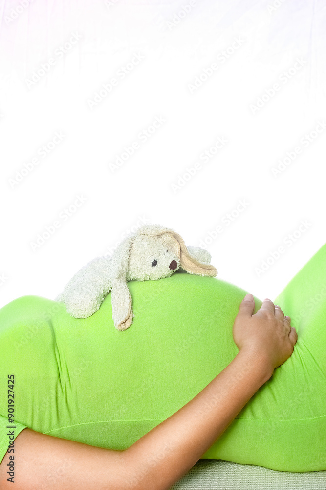 Happy pregnant girl lies on white background Happy pregnant girl lies on white background