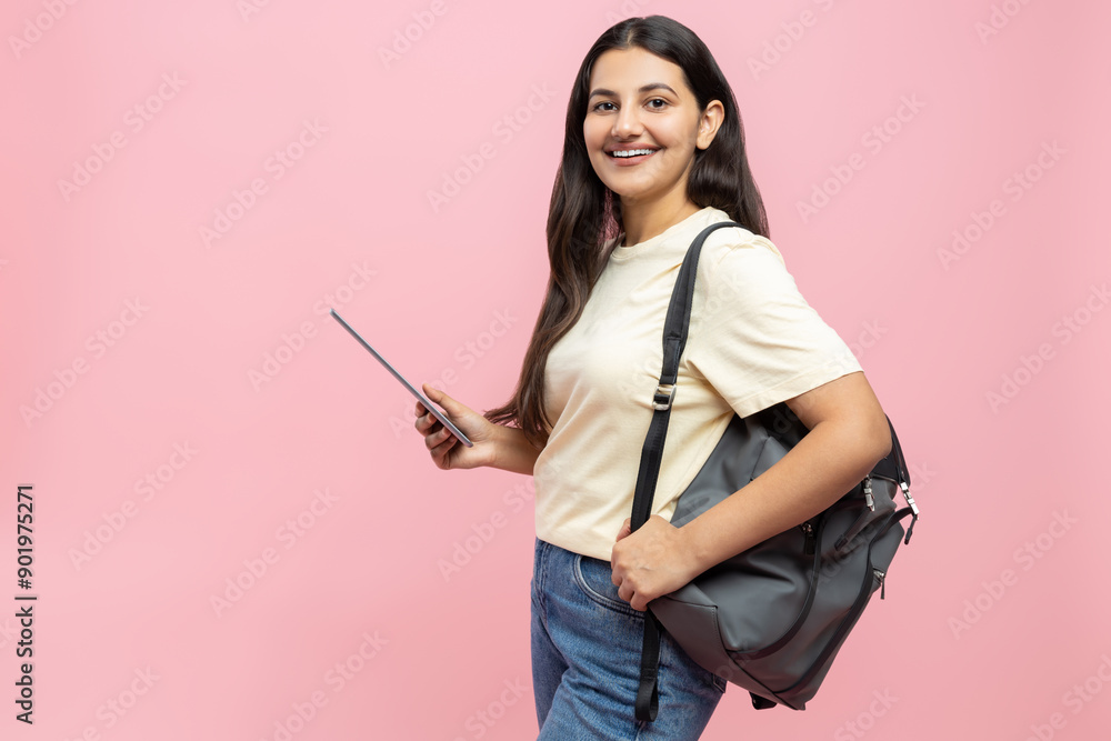 Cheerful young student girl with backpack using digital tablet for remote education