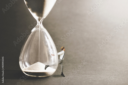 surreal man runs away from an hourglass where time flows inexorably, abstract concept photo