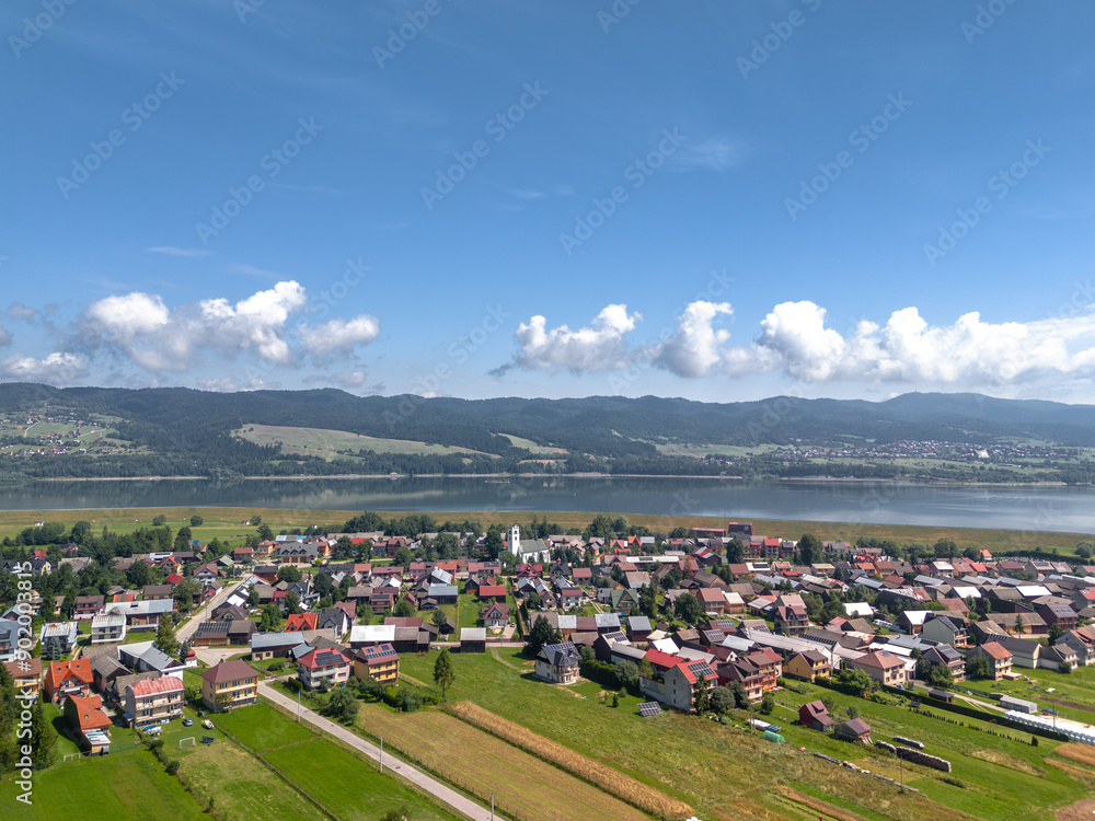 Summer skyline cityscape of Frydman village at Czorsztyn lake (Jezioro Czorsztyńskie) in Lesser Poland (Małopolska), Poland. Wide panoramic aerial view