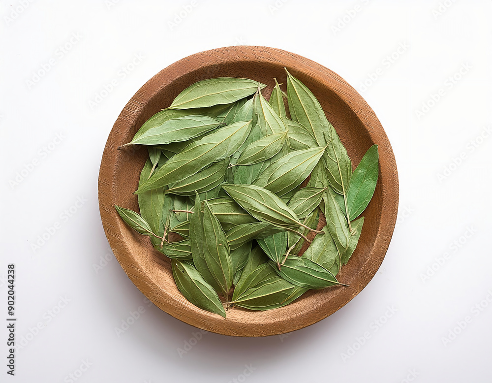 Bay leaves in wooden bowl isolated on white background. Top view. Bay leaves in wooden bowl isolated on white background. Top view.