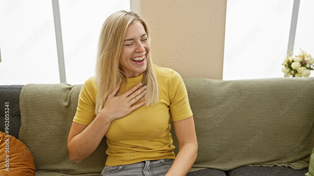 Smiling blonde woman enjoying leisure time in a cozy living room setting Smiling blonde woman enjoying leisure time in a cozy living room setting