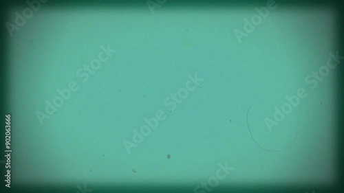 Vintage turquoise film background with vignette. Copy space on centre. Old retro film camera, textured background. Scratches, details and noise. Dusty and grainy feel. 4K motion graphics