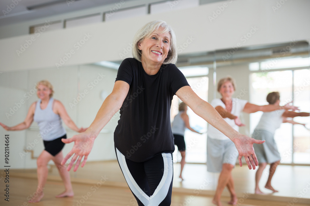 Obraz premium Group of three mature women performing modern dance in exercise room.