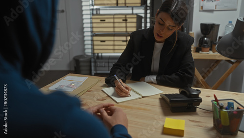 Obraz na płótnie Woman investigator interrogates a man in an office, with passports and a notepad on the desk
