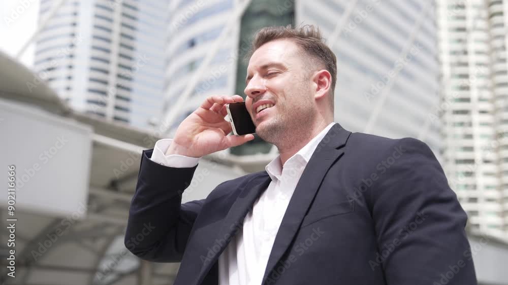 Smart caucasian businessman calling his colleague to plan financial strategy while standing at urban city. Project manager using his mobile phone to communicate with marketing team. Lifestyle. Urbane. Smart caucasian businessman calling his colleague to plan financial strategy while standing at urban city. Project manager using his mobile phone to communicate with marketing team. Lifestyle. Urbane.