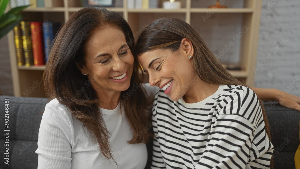 Affectionate mother and daughter smiling and embracing in a cozy living room, showcasing love and family connection. Affectionate mother and daughter smiling and embracing in a cozy living room, showcasing love and family connection.