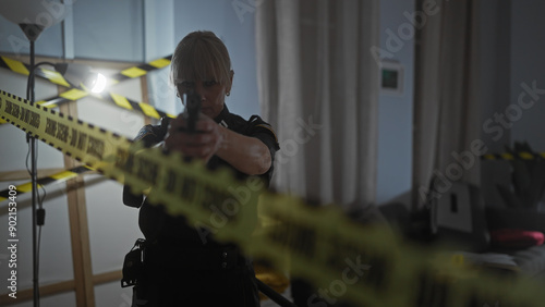 Focused woman police officer aiming gun in crime scene indoors with caution tape and blurred foreground