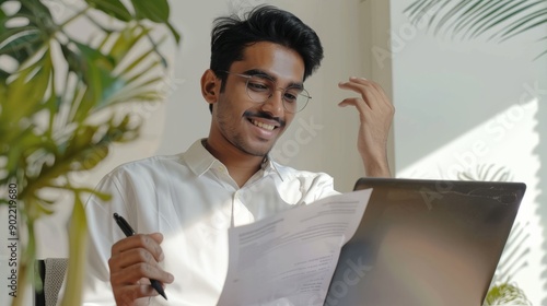 Fashion style photos, smilingly looks at a laptop, talks on a video call, hol...