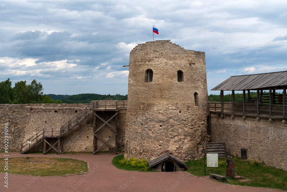 View of the wall of the Izborsk fortress and Lukovka Tower on a sunny summer day, Izborsk, Pskov region, Russia View of the wall of the Izborsk fortress and Lukovka Tower on a sunny summer day, Izborsk, Pskov region, Russia