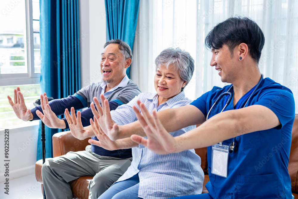 Obraz premium Senior Asian couple get medical service visit from male caregiver nurse at home while doing physical therapy to shoulder stretching for muscle pain in health care and pension welfare
