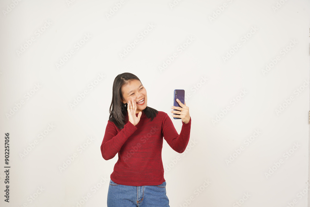 Young Asian woman doing video call using smartphone and wearing red t-shirt isolated on white background Young Asian woman doing video call using smartphone and wearing red t-shirt isolated on white background
