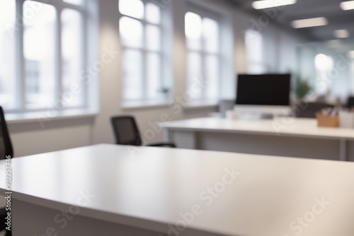 Blurred minimalist modern office interior with sleek desk ergonomic chair and large window